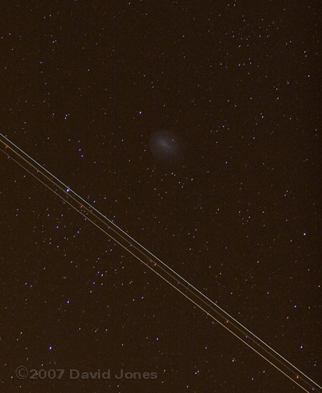 An aircraft passes Comet Holmes - 1