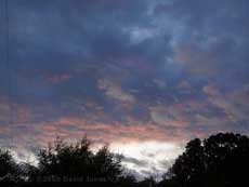 A bit of brightness sneaks under the clouds at sunset